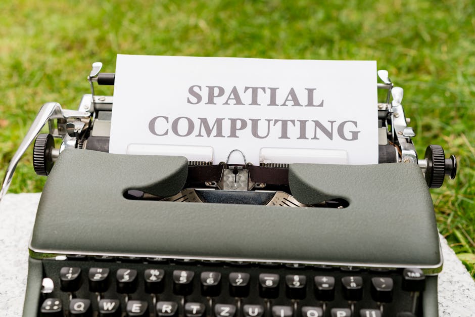 A vintage typewriter displays 'Spatial Computing' on paper in an outdoor setting.