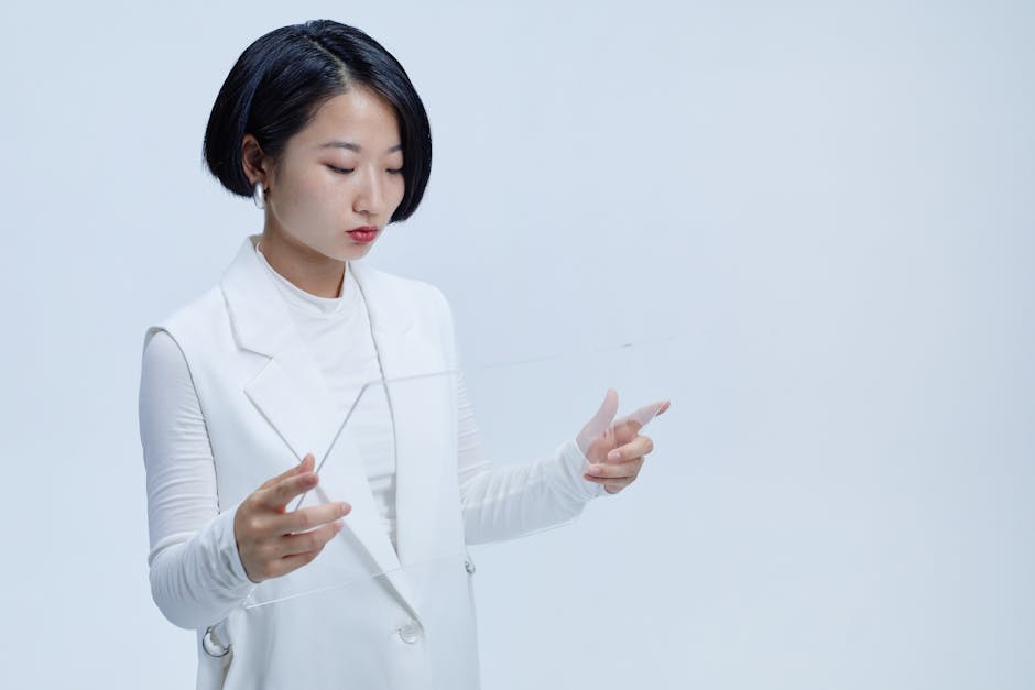 Young woman interacting with a futuristic transparent screen, showcasing modern technology concepts.