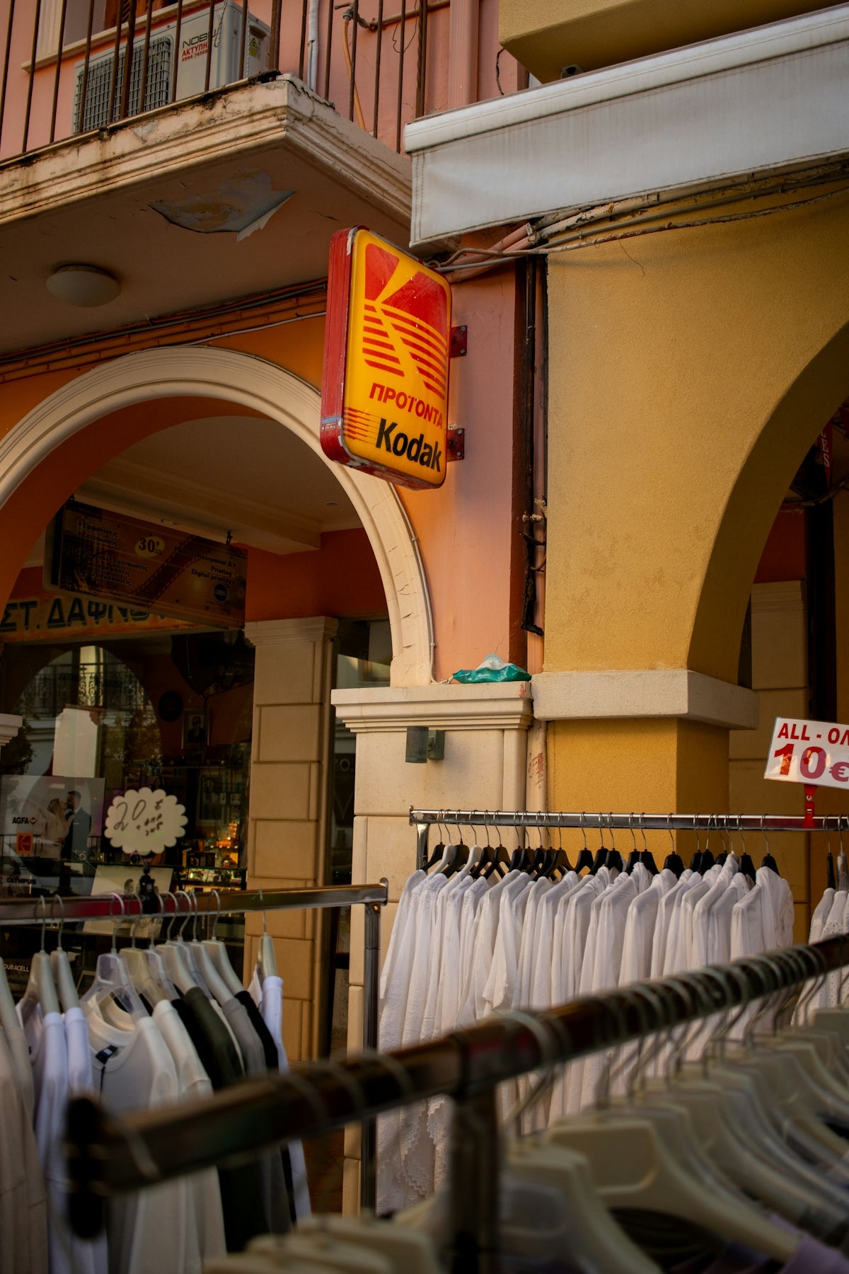 A store front with a bunch of shirts on racks