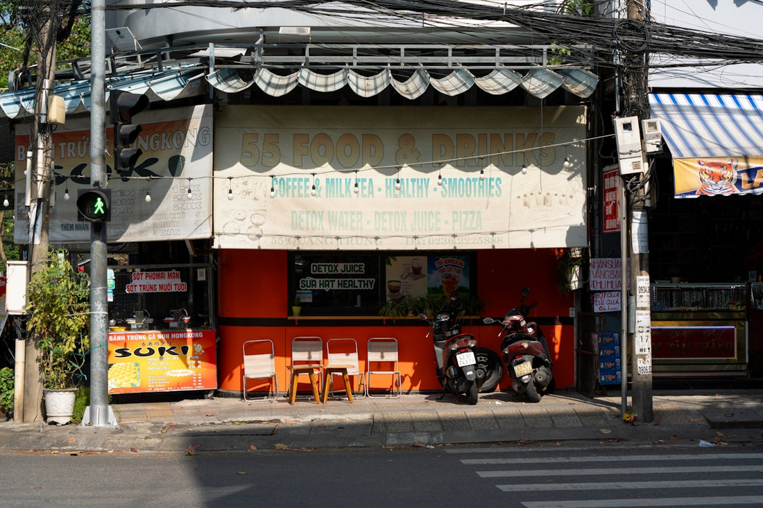 A small storefront with motorbikes parked outside.