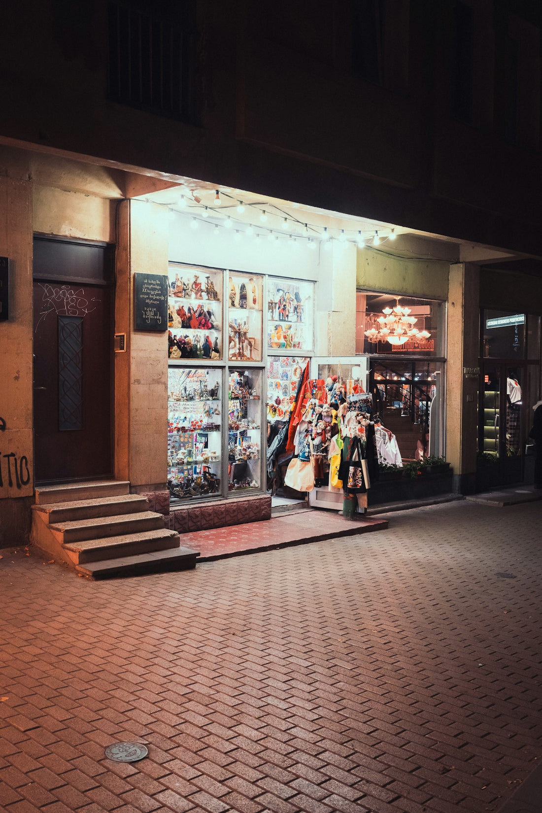 A brightly lit store at night with products displayed.