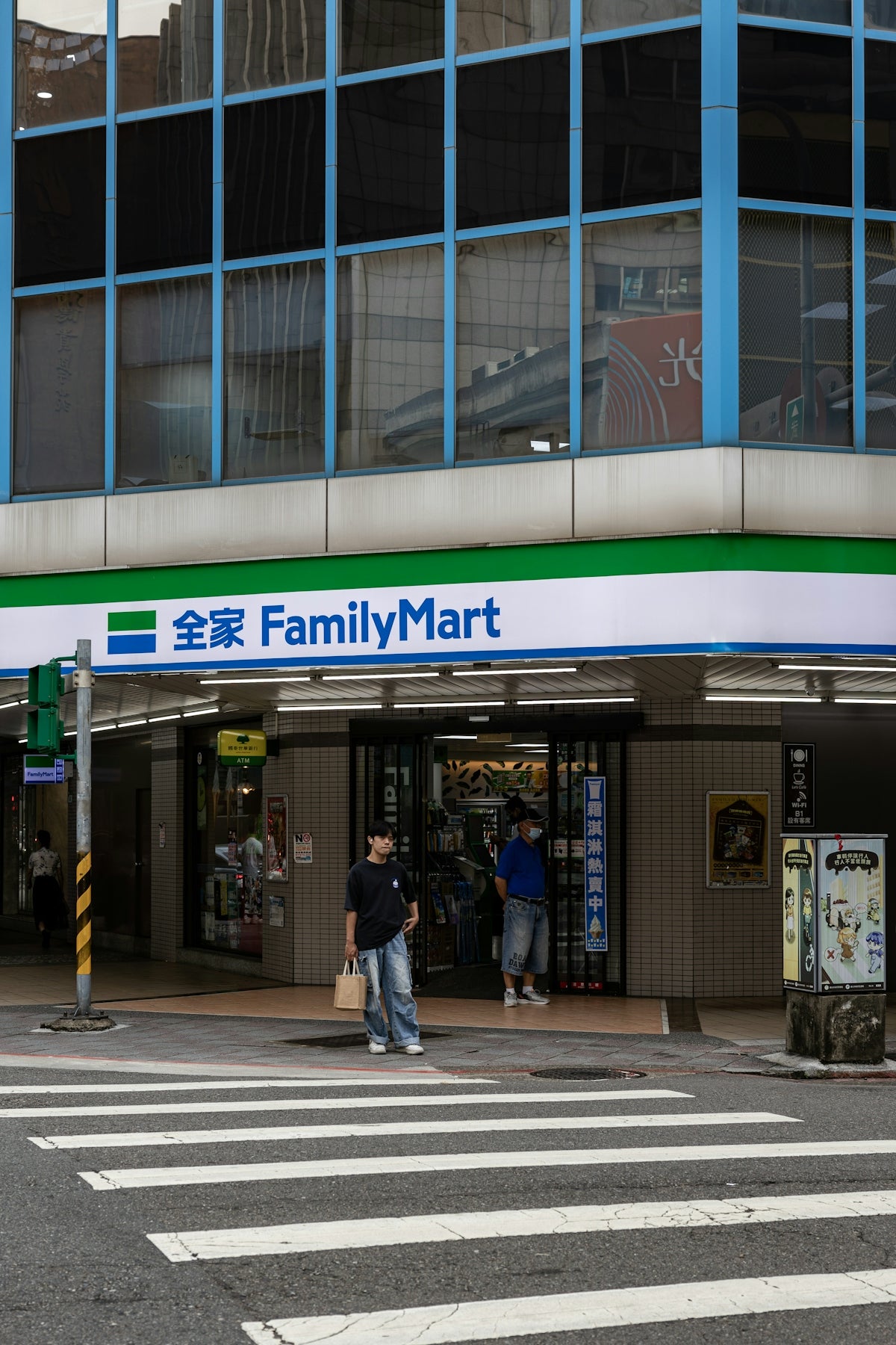 Familymart convenience store entrance with people outside